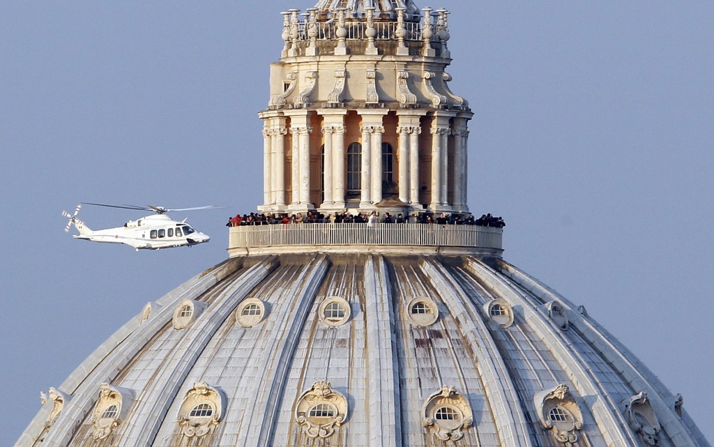 Helicopter carrying Pope Benedict XVI flies past St. Peter's Basilica as it leaves Vatican