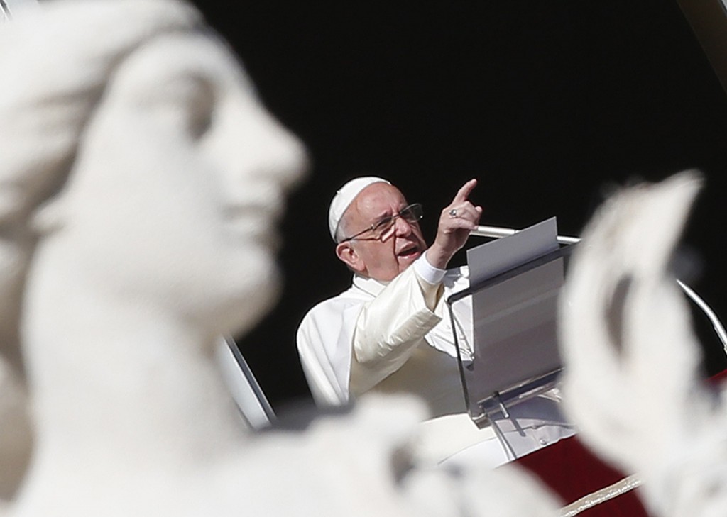 Pope Francis gestures as he leads Angelus at Vatican Jan. 1